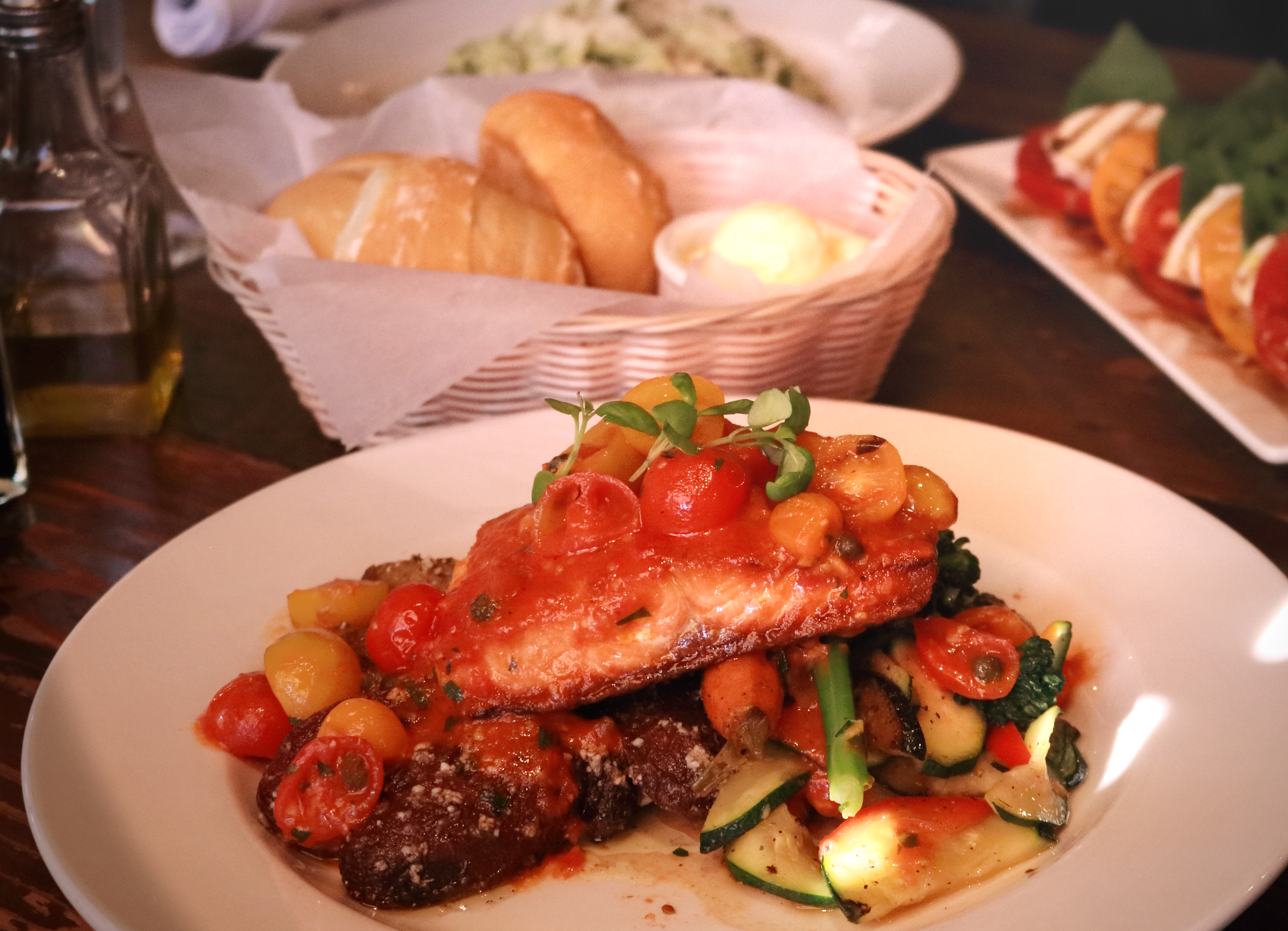 Pan seared steelhead trout, heirloom cherry tomatoes, capers, garlic; served with roasted fingerling potatoes and seasonal vegetables